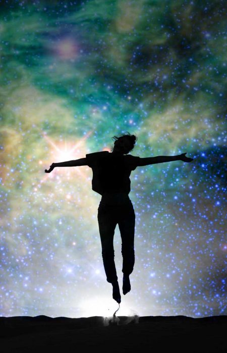 Silhouette of a woman jumping, starry night background