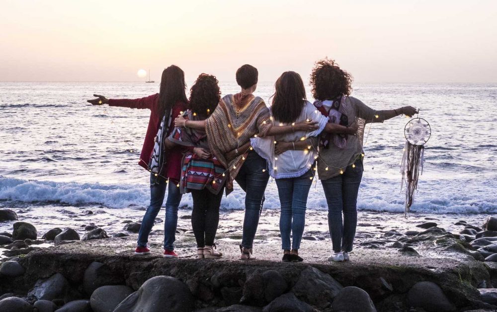 Love and friendship concept with group of female people enjoying the sunset on the ocean together - Love and friendship concept with group of female people enjoying the sunset on the ocean together -